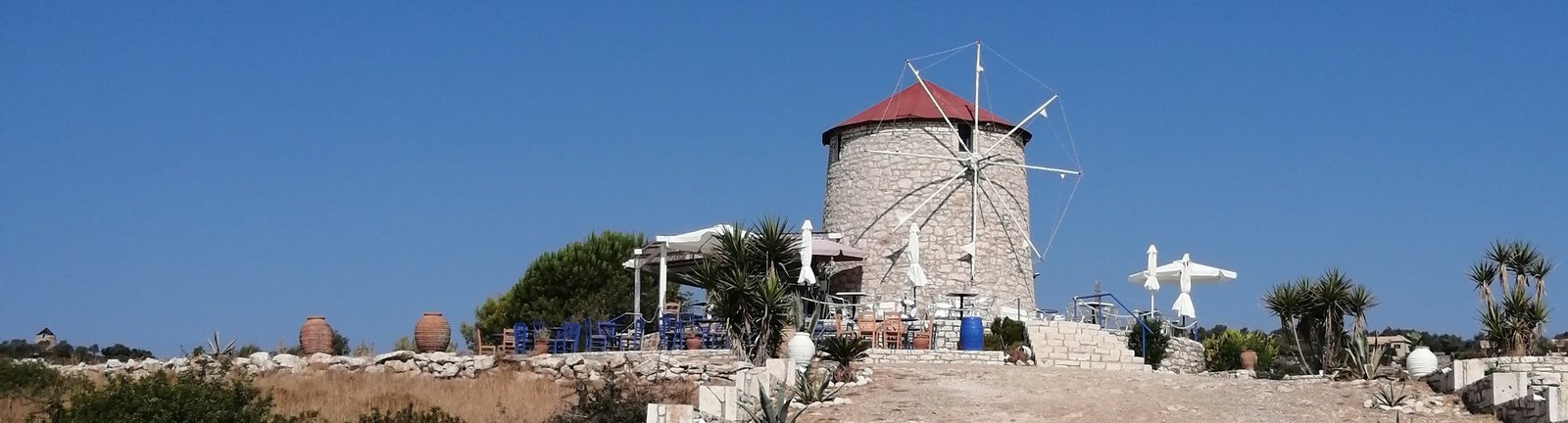 Walking path leading to a historic windmill in Greece